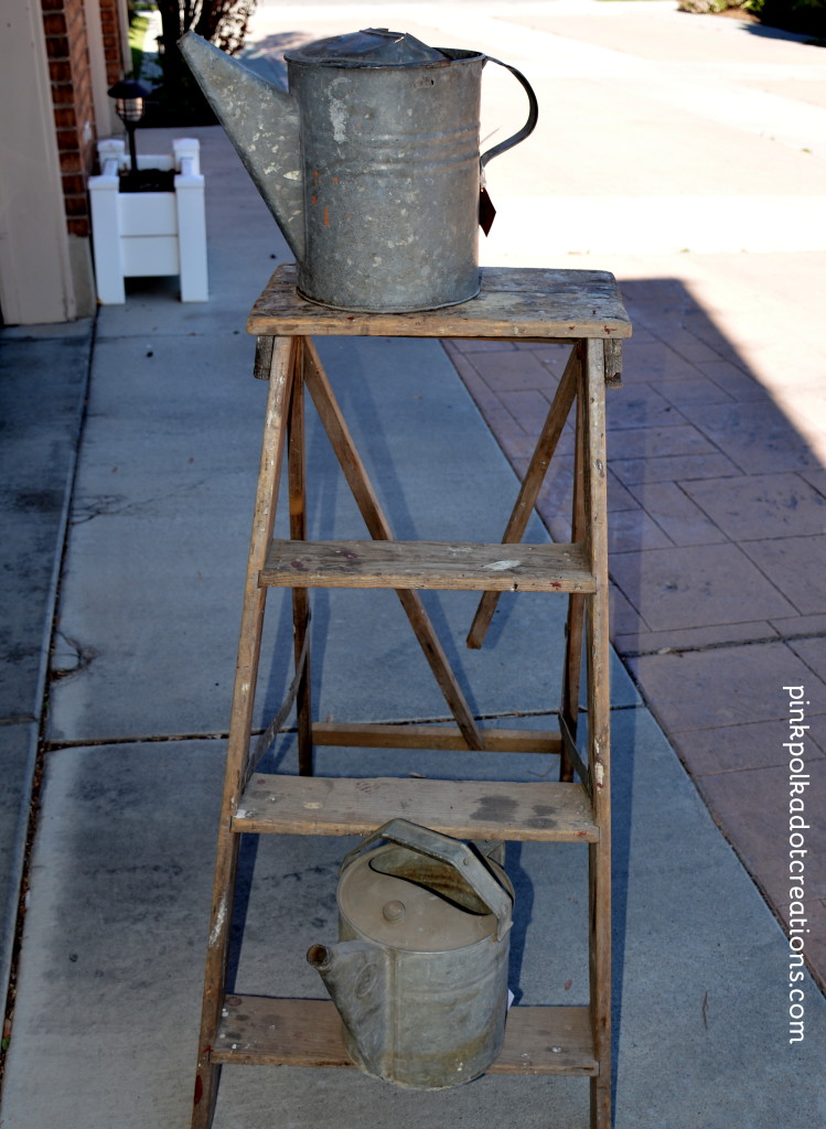 antique ladder and watering cans